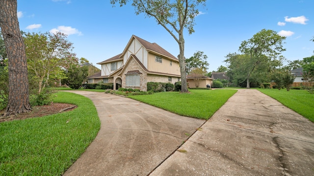 tudor-style house with a front yard