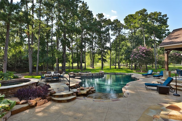 view of pool with a patio, a yard, and an in ground hot tub