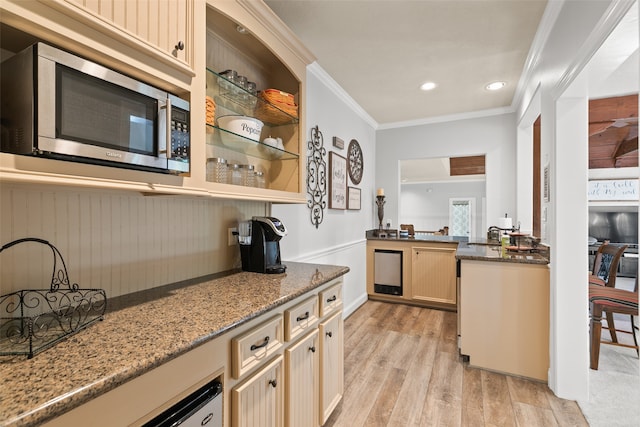 kitchen featuring light hardwood / wood-style flooring, light brown cabinets, crown molding, and light stone countertops