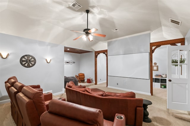 carpeted home theater with ceiling fan and vaulted ceiling