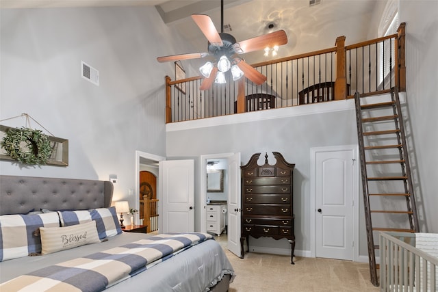 carpeted bedroom featuring ensuite bathroom, high vaulted ceiling, and ceiling fan