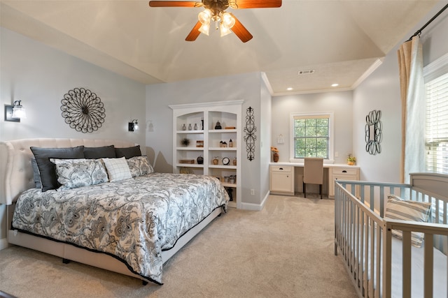 carpeted bedroom featuring ceiling fan and ornamental molding