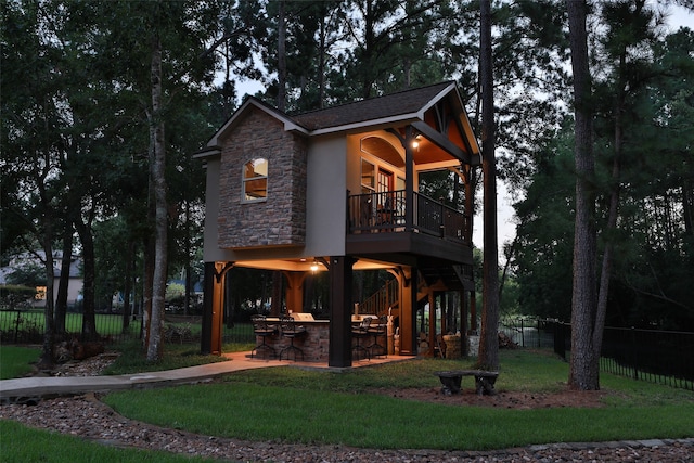 exterior space featuring a bar and a yard