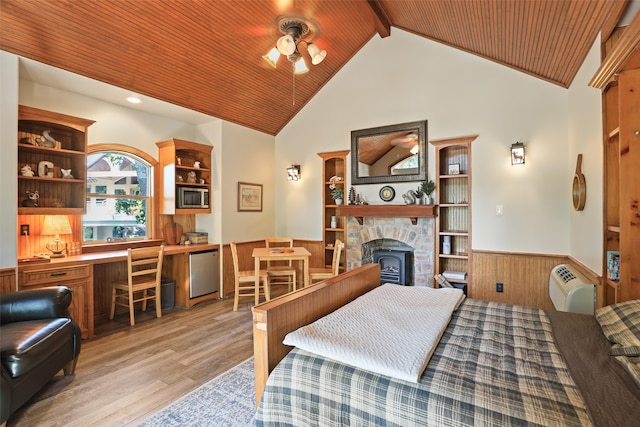 bedroom with high vaulted ceiling, a fireplace, light hardwood / wood-style floors, beamed ceiling, and wood ceiling