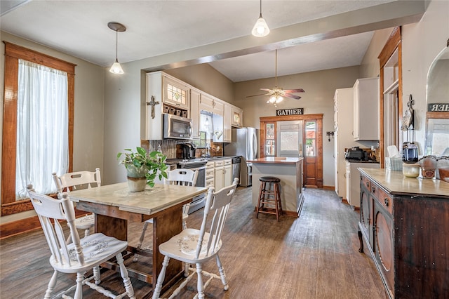 dining space with ceiling fan and dark hardwood / wood-style floors