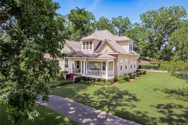 craftsman-style house with a front lawn and covered porch