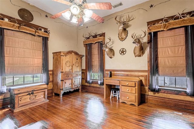 office space featuring ceiling fan, a healthy amount of sunlight, and hardwood / wood-style flooring