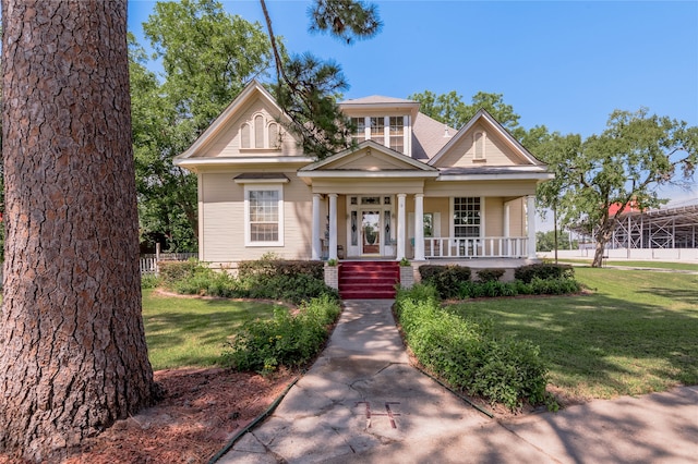 view of front of home with a front yard and covered porch