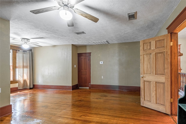 spare room with hardwood / wood-style floors, a textured ceiling, and ceiling fan