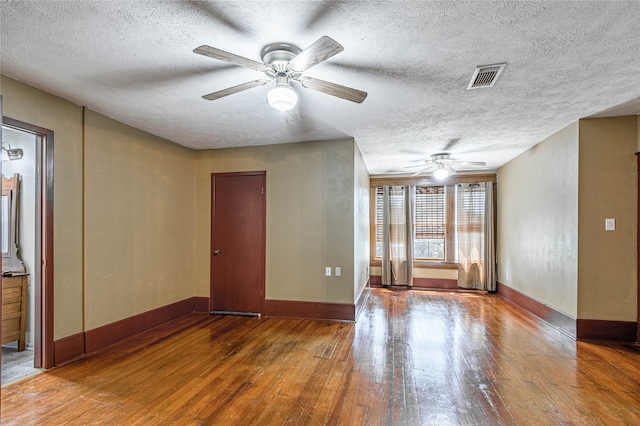 interior space featuring ceiling fan, wood-type flooring, and a textured ceiling