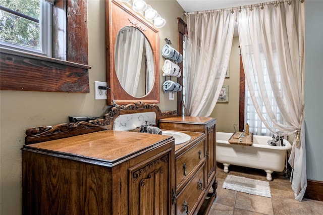 bathroom featuring vanity, a bathtub, and tile patterned flooring