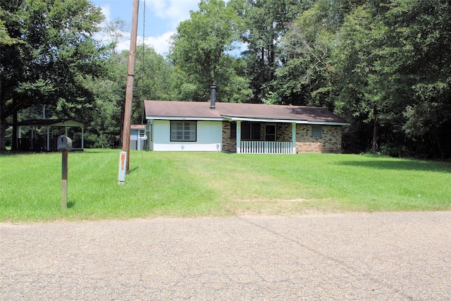 ranch-style house featuring a porch and a front lawn