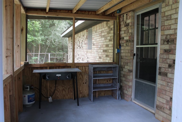 sunroom featuring beam ceiling