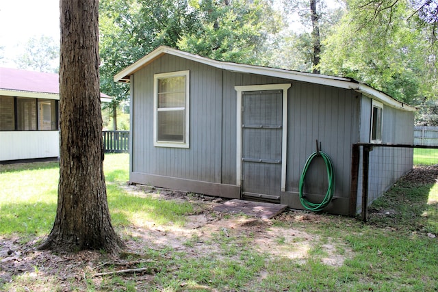 view of outbuilding with a lawn