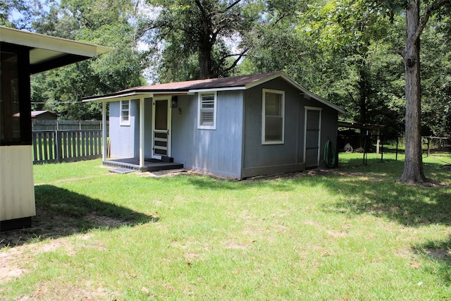 view of outbuilding featuring a yard