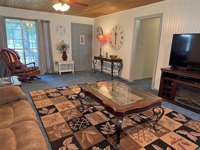 living room featuring ceiling fan, wood ceiling, and dark carpet