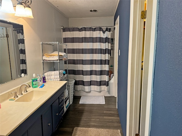 bathroom with shower / tub combo, vanity, and hardwood / wood-style flooring