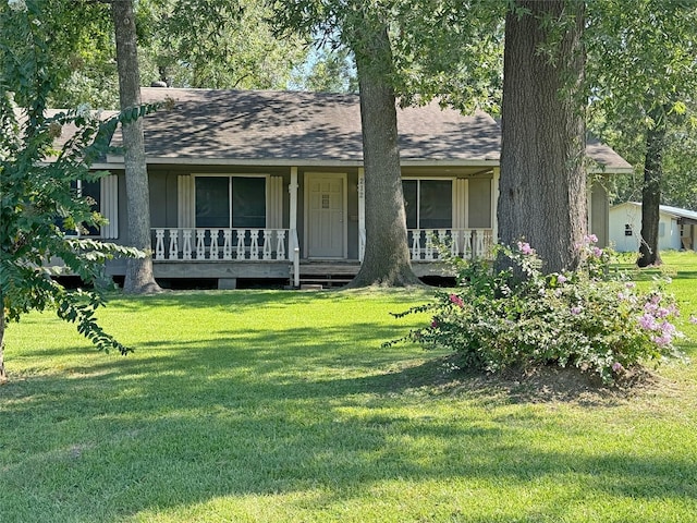 ranch-style home with covered porch and a front yard