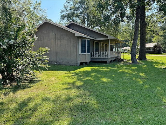 view of home's exterior featuring a yard and a porch