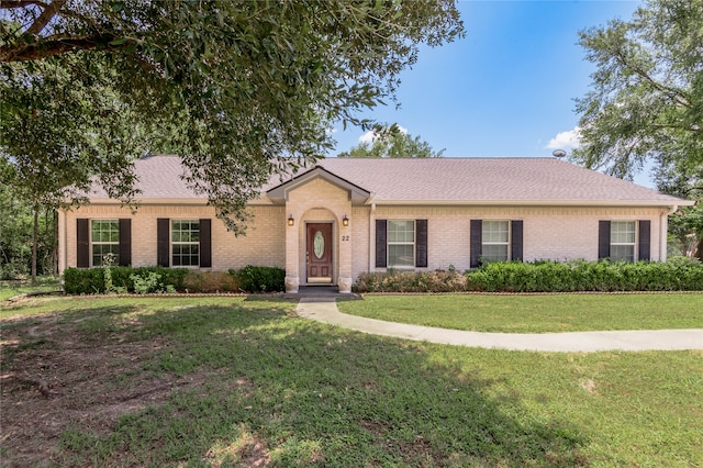 ranch-style house with a front lawn