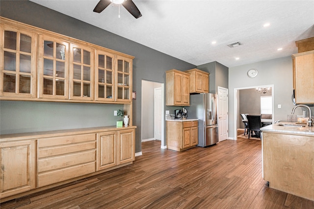 kitchen featuring dark hardwood / wood-style flooring, ceiling fan, sink, light brown cabinets, and stainless steel fridge