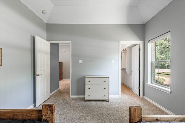 bedroom featuring lofted ceiling and light colored carpet