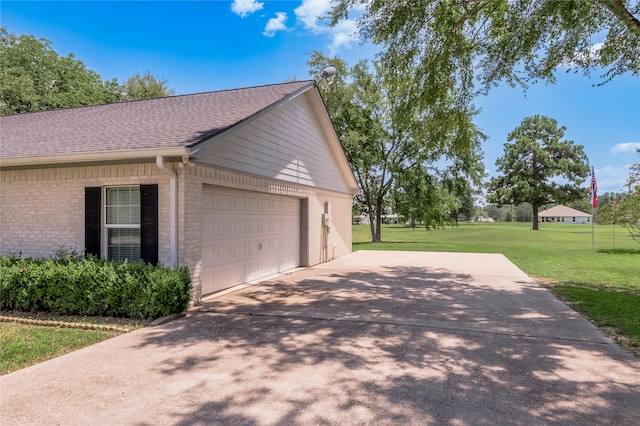 view of home's exterior with a lawn and a garage