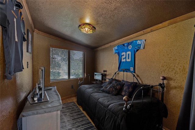 bedroom with wood-type flooring, lofted ceiling, and a textured ceiling