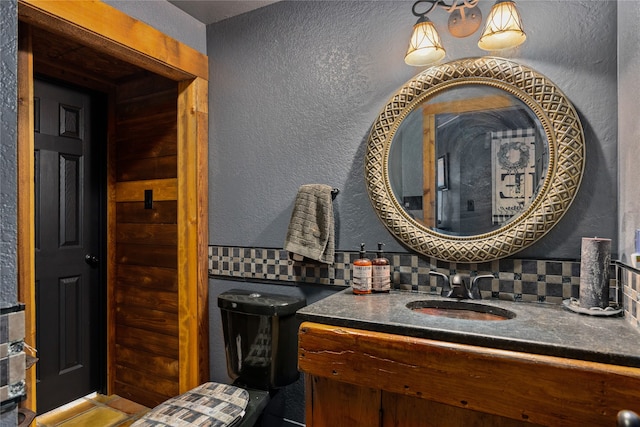 bathroom featuring toilet, tasteful backsplash, and vanity