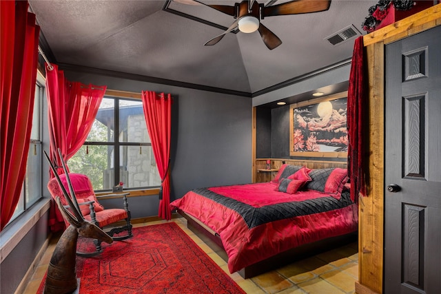 bedroom with ceiling fan, vaulted ceiling, ornamental molding, and a textured ceiling