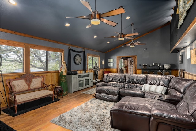 living room with ceiling fan, high vaulted ceiling, and light hardwood / wood-style flooring