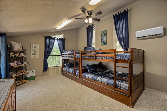 carpeted bedroom featuring ceiling fan, a textured ceiling, and a wall mounted air conditioner