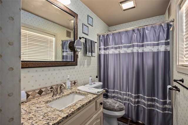 bathroom with vanity, toilet, and a shower with shower curtain