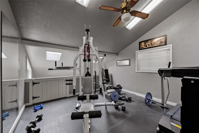 exercise room with ceiling fan, lofted ceiling, and a textured ceiling