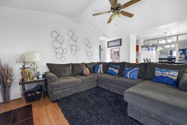 living room featuring hardwood / wood-style floors, lofted ceiling with beams, and ceiling fan with notable chandelier