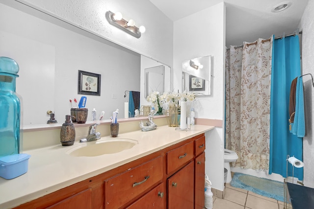 bathroom featuring vanity, tile patterned flooring, and toilet