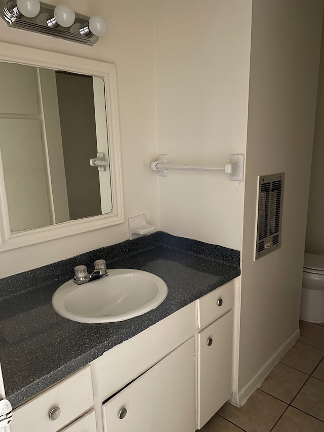 bathroom with vanity, toilet, and tile patterned flooring