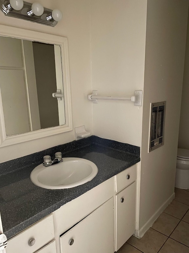 bathroom featuring visible vents, vanity, toilet, and tile patterned floors