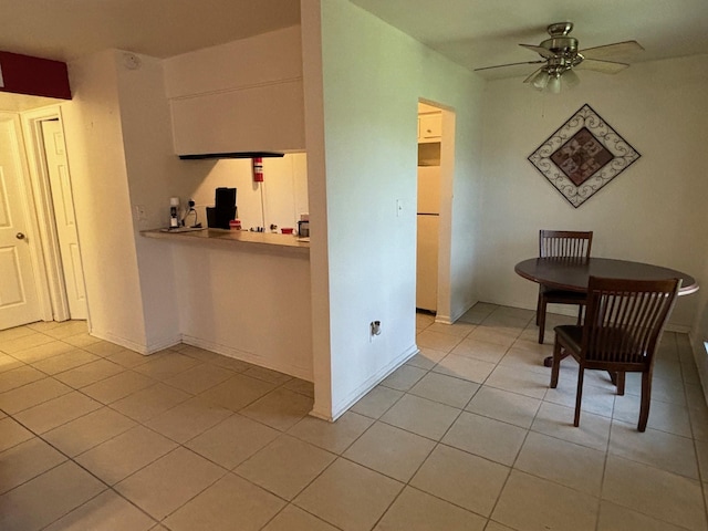 interior space with baseboards and light tile patterned floors