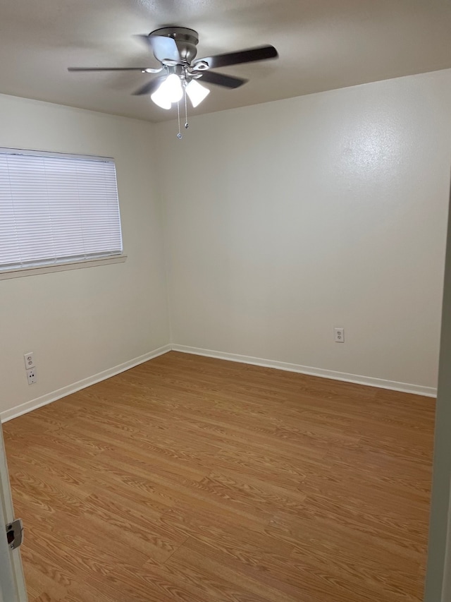 unfurnished room with ceiling fan and wood-type flooring