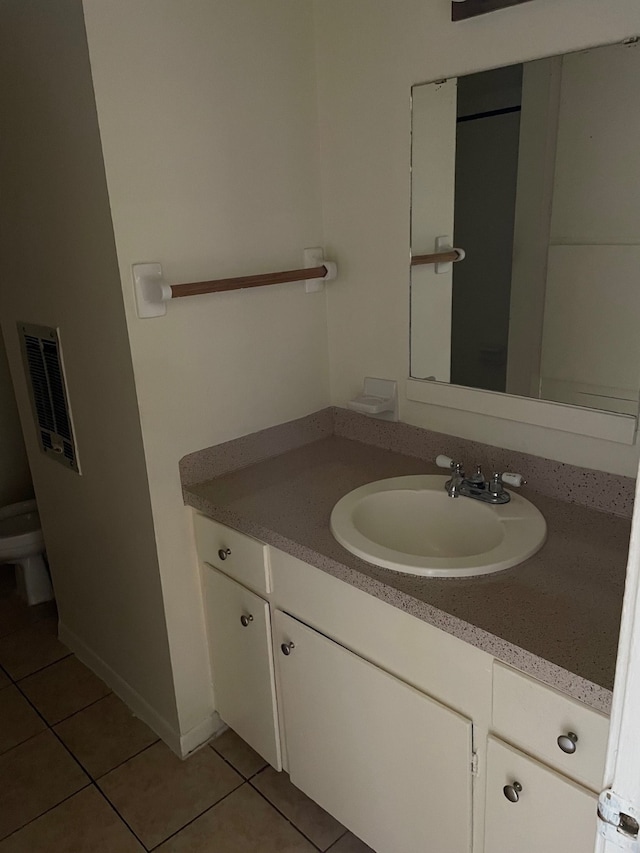 bathroom featuring vanity, toilet, and tile patterned flooring