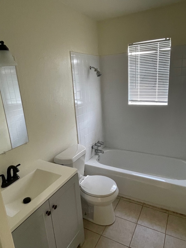 full bathroom featuring toilet, tiled shower / bath, vanity, and tile patterned flooring