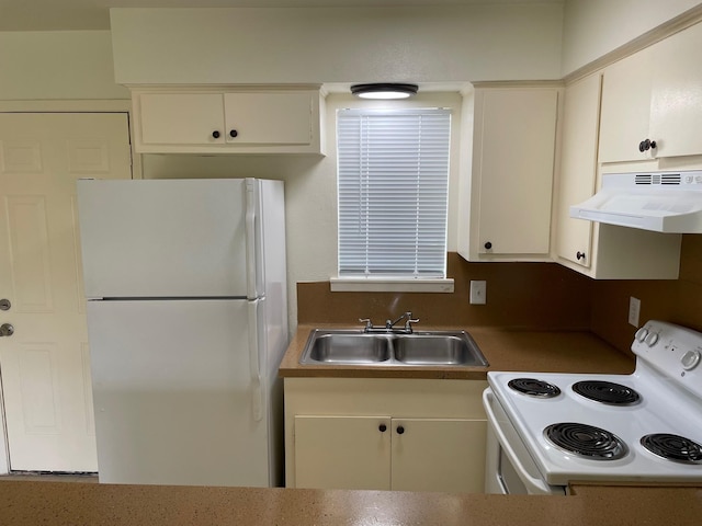 kitchen featuring white appliances, white cabinets, a sink, and under cabinet range hood