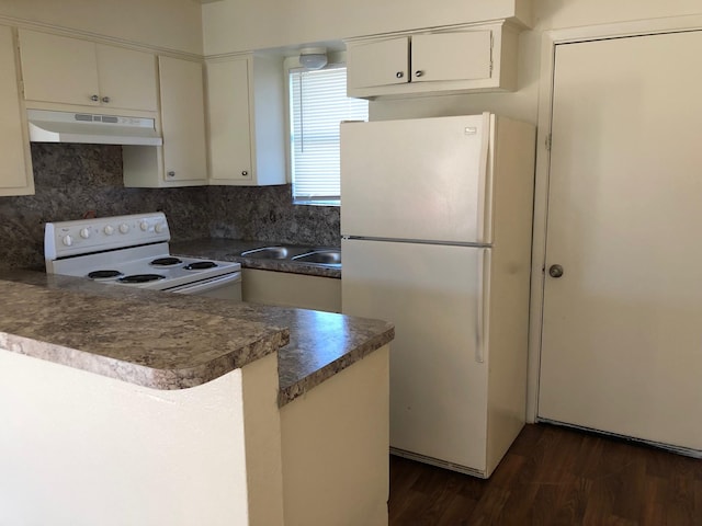 kitchen featuring white appliances, dark wood-style flooring, a peninsula, under cabinet range hood, and white cabinetry