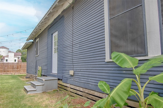 view of side of home featuring a lawn