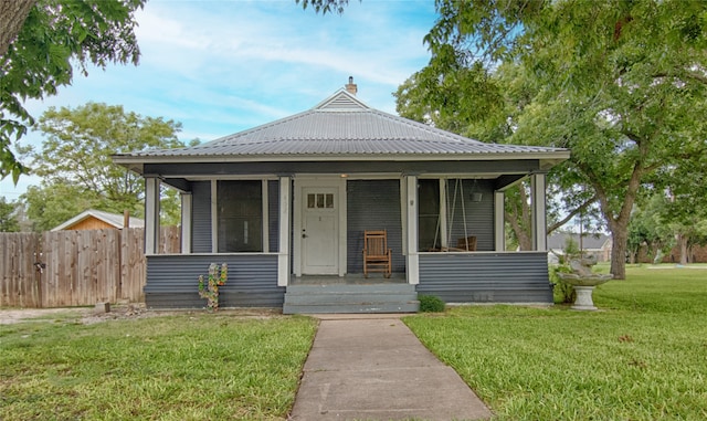 bungalow featuring a porch and a front yard