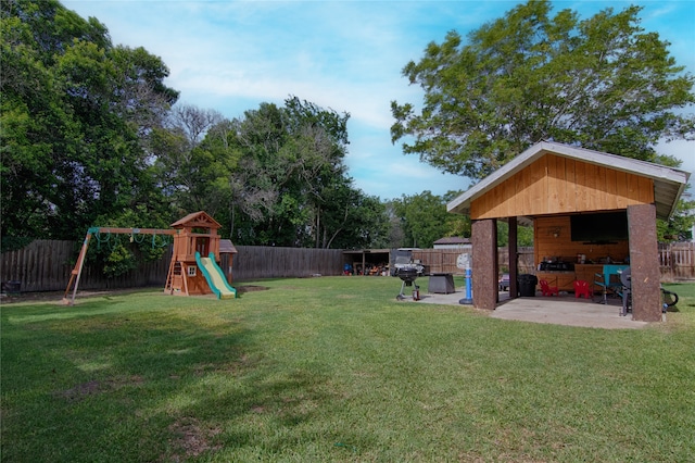 view of yard with a patio area and a playground