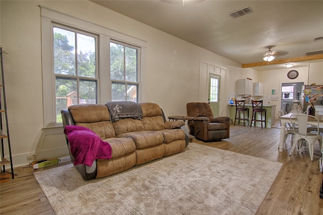 living room featuring ceiling fan and light hardwood / wood-style flooring