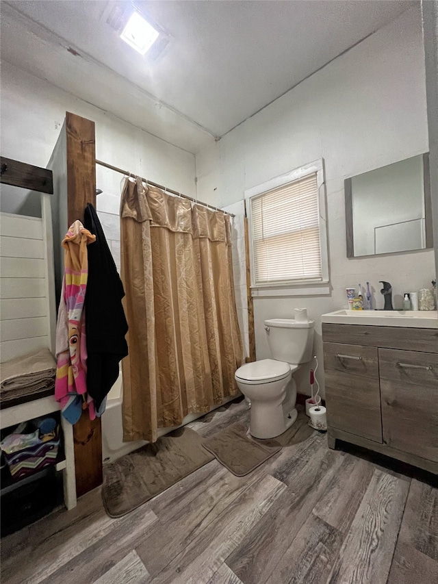 full bathroom with shower / bath combo, toilet, vanity, and hardwood / wood-style flooring