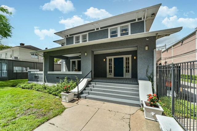 view of front facade featuring a front yard and a porch